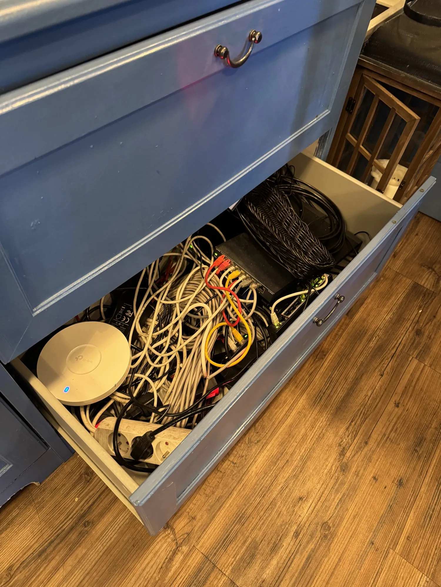 Network cabling and an access point lying loose in a dresser drawer