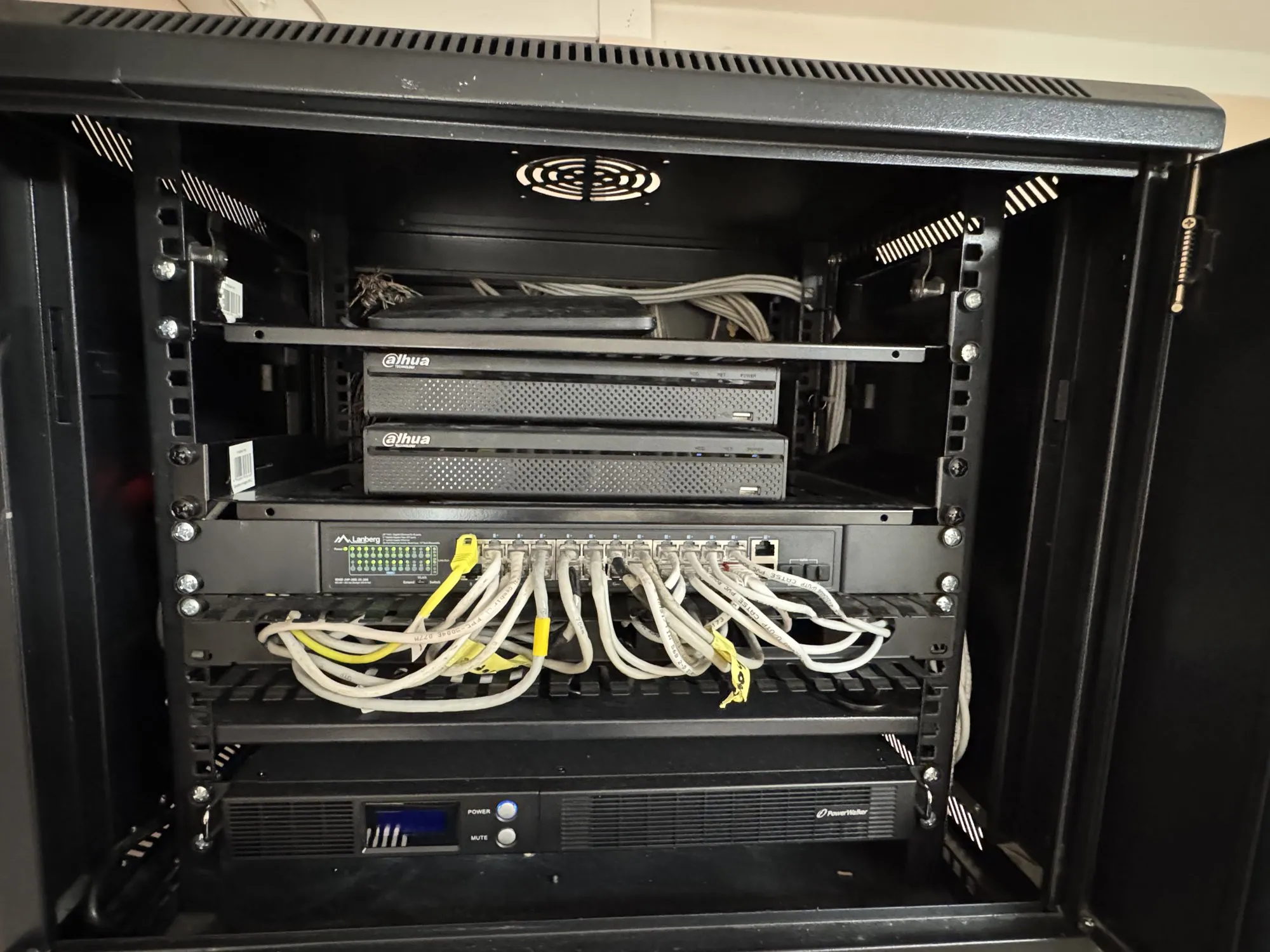 The same rack cabinet with the cabling routed through a cable comb